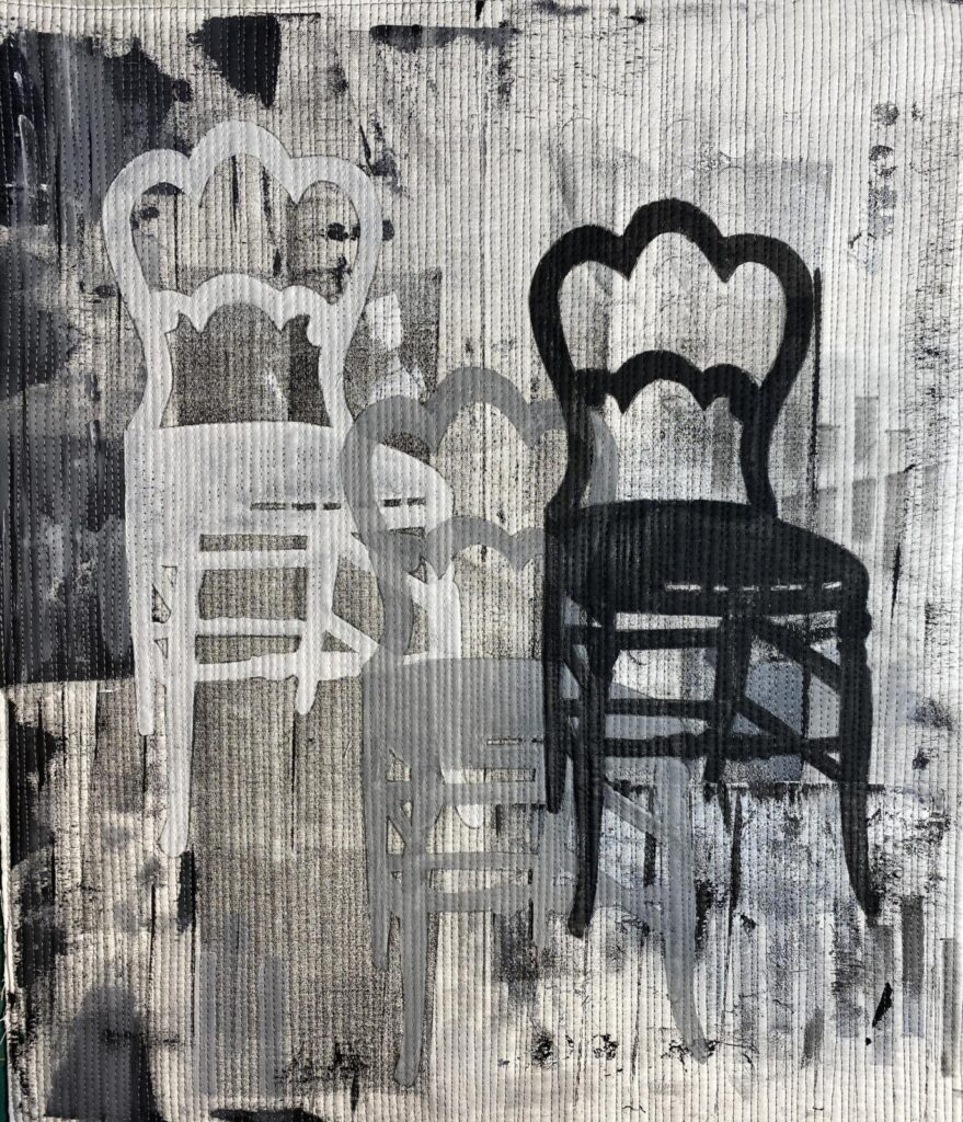 three chairs on painted fabric