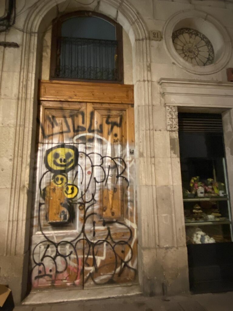 Wooden door in Barcelona tagged