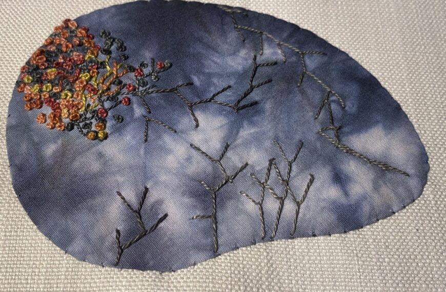 Gray rock embellished with colonial knots and fly stitch