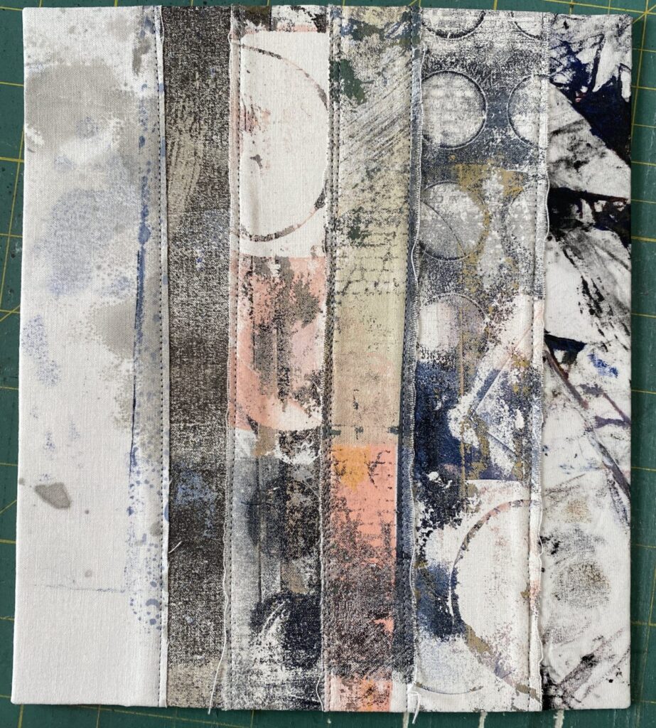 an image showing a page of a new textile book made with strips of different painted, monoprinted and dyed fabrics