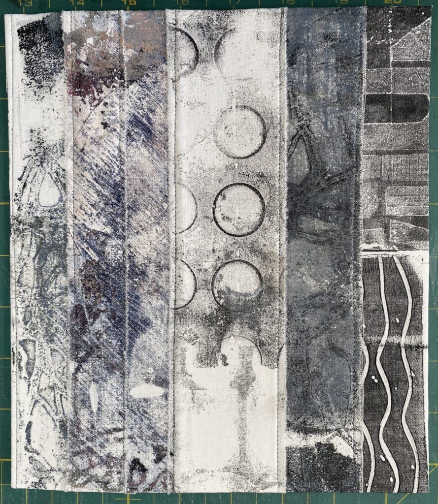 an image showing a page of a new textile book made with strips of different painted, monoprinted and dyed fabrics