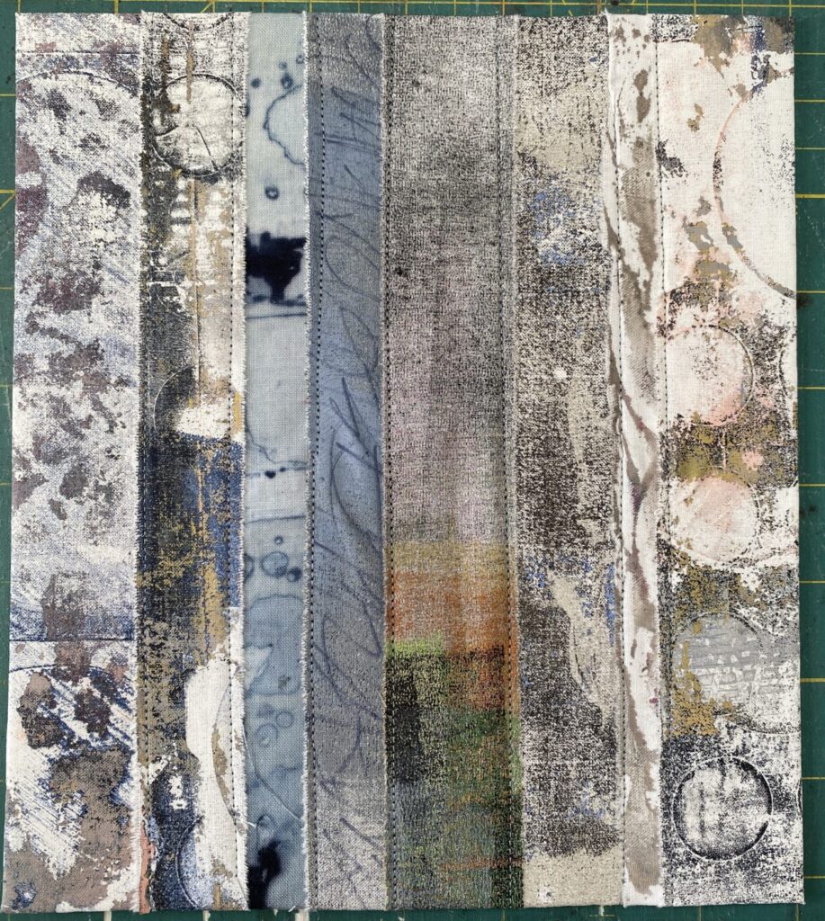 an image showing a page of a new textile book made with strips of different painted, monoprinted and dyed fabrics