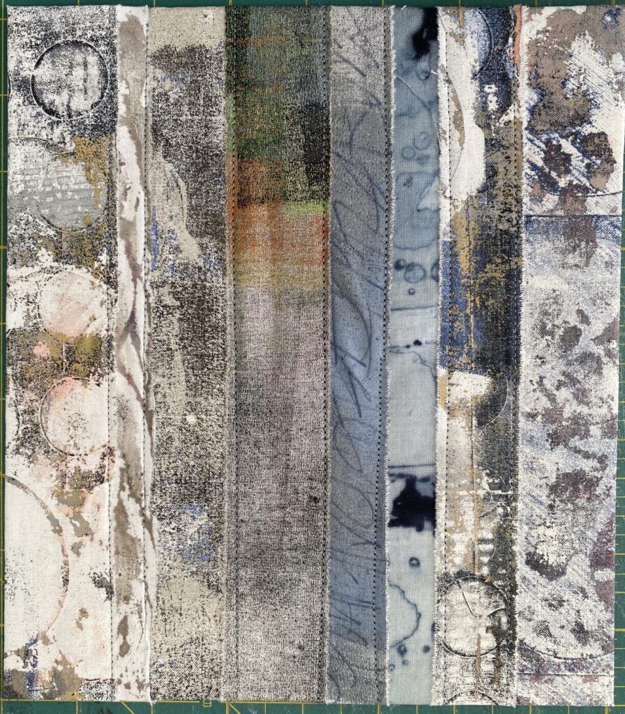 an image showing a page of a new textile book made with strips of different painted, monoprinted and dyed fabrics