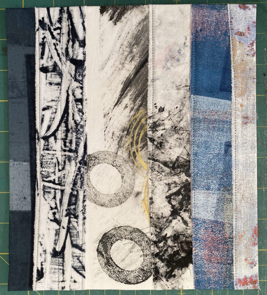 an image showing a page of a new textile book made with strips of different painted, monoprinted and dyed fabrics