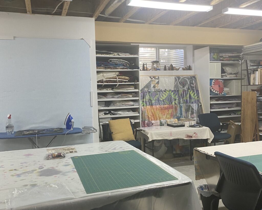 a shot of my downstairs studio showing the design wall, shelving units and miscellaneous