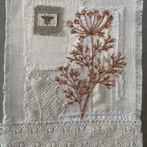 an image showing a small collage of fabrics, ribbon and lace hand stitched to linen with a design hand-stitched in reddish brown of a dill plant