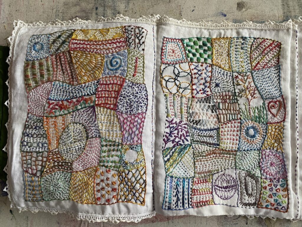 An image showing two completed months of the stitch journal and sewn into a book - January and February 2025