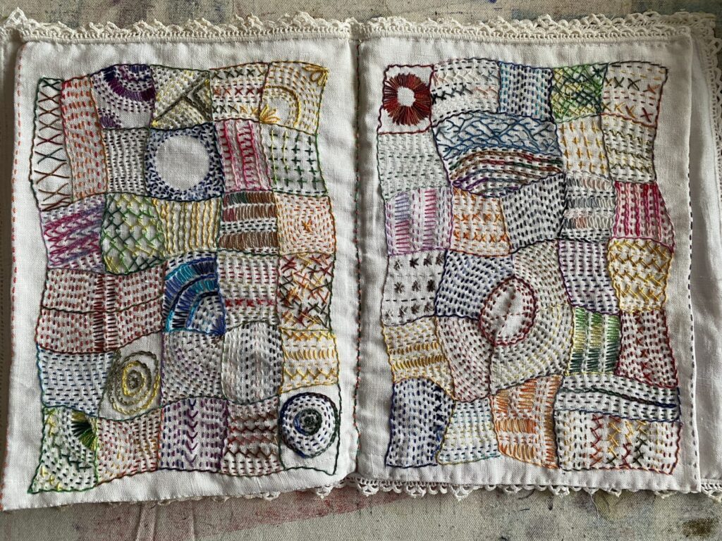 An image showing two completed months of the stitch journal and sewn into a book - September and October