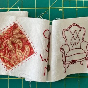 an image showing a piece of the come sit with me scroll where you can appreciate some of the fabrics used, the stitching and some buttons and details.