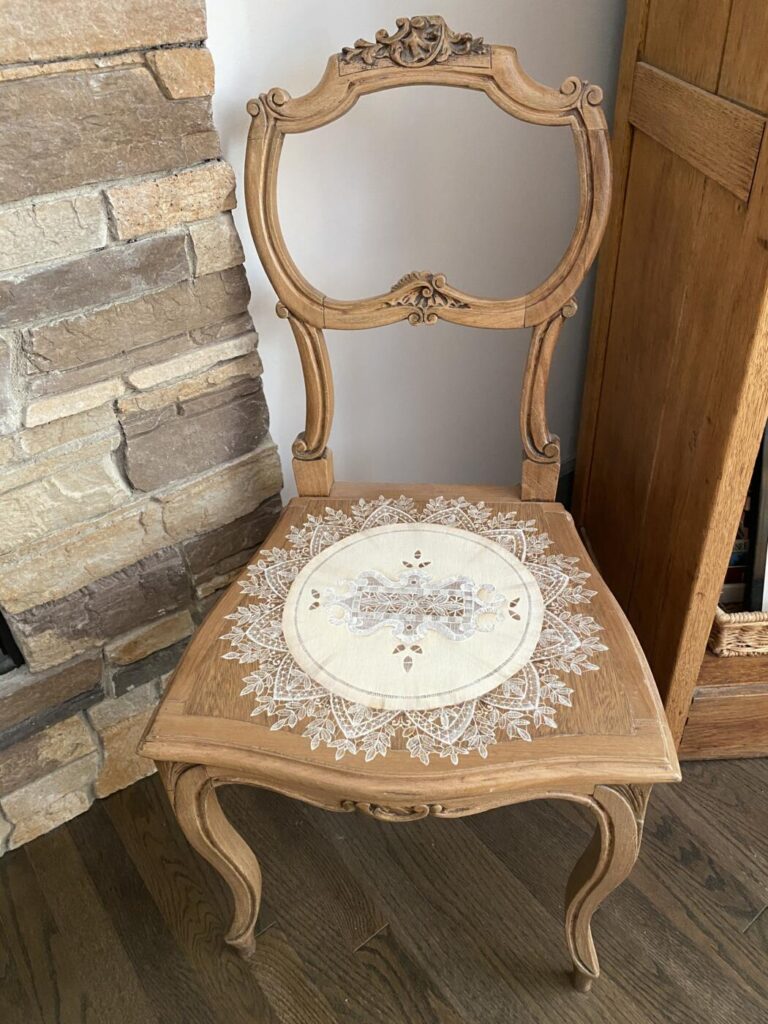 an image showing a vintage chair with a lace "doily" painted on the seat. Inspired by Italian lace
