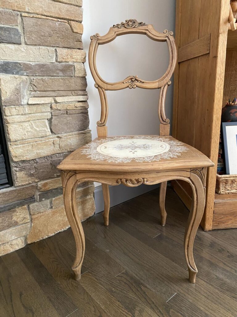 an image showing a vintage chair with a lace "doily" painted on the seat. Inspired by Italian lace