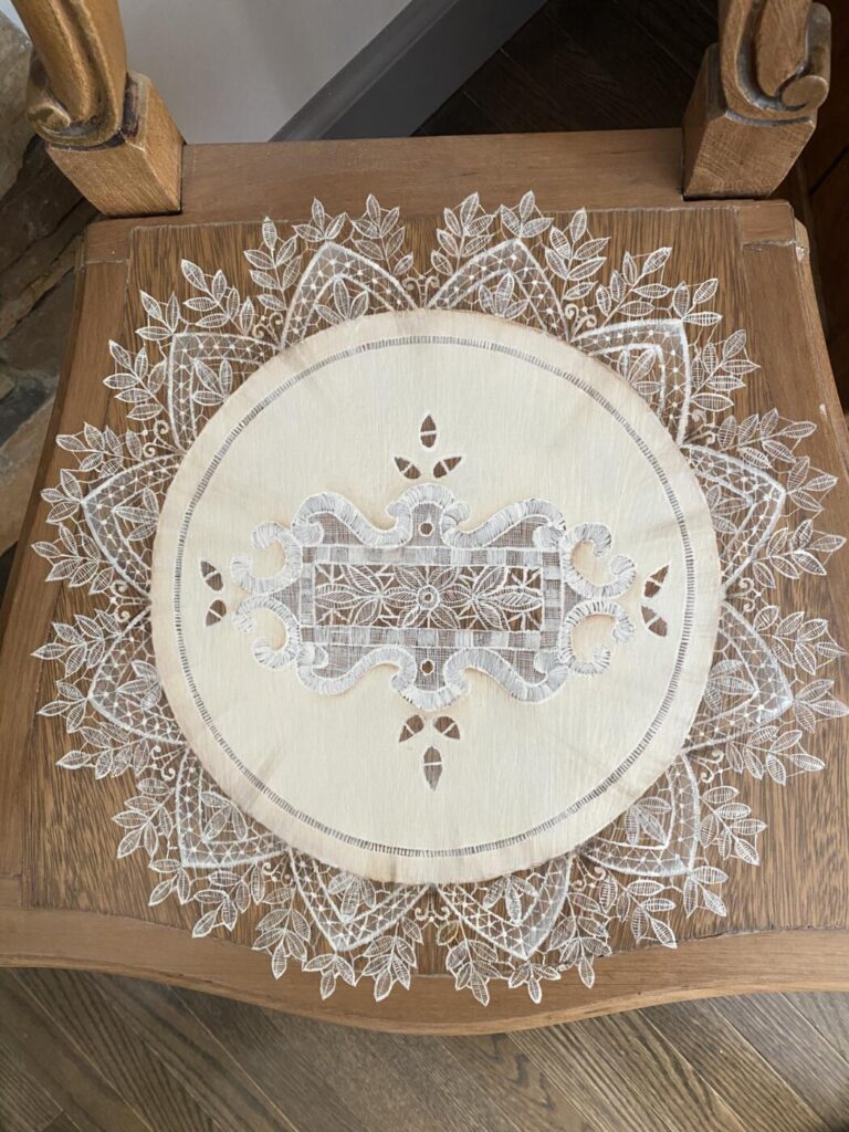 an image showing a vintage chair with a lace "doily" painted on the seat. Inspired by Italian lace - close up
