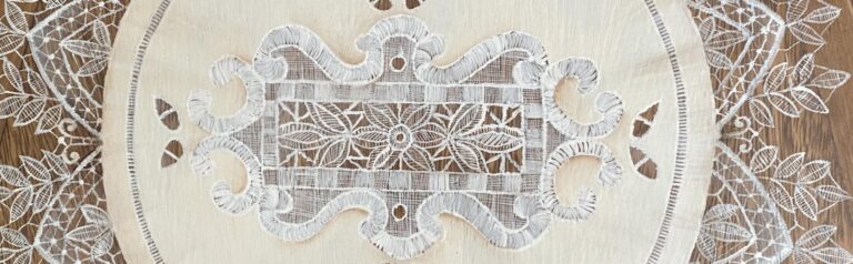 an image showing a close up of the italian lace painted on the seat of the vintage chair