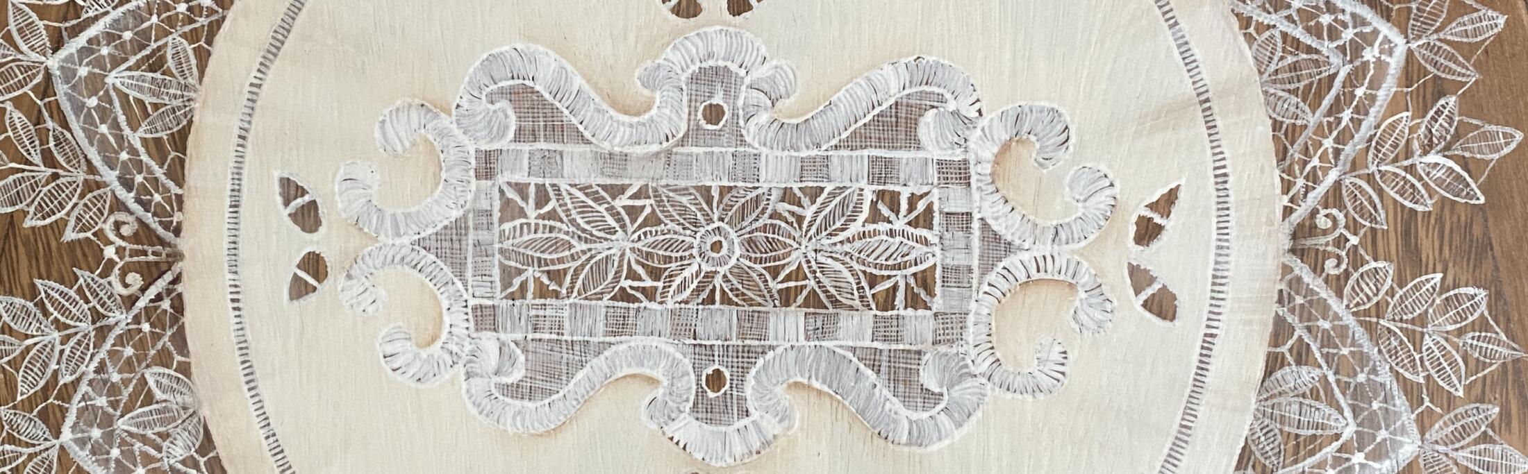 an image showing a close up of the italian lace painted on the seat of the vintage chair