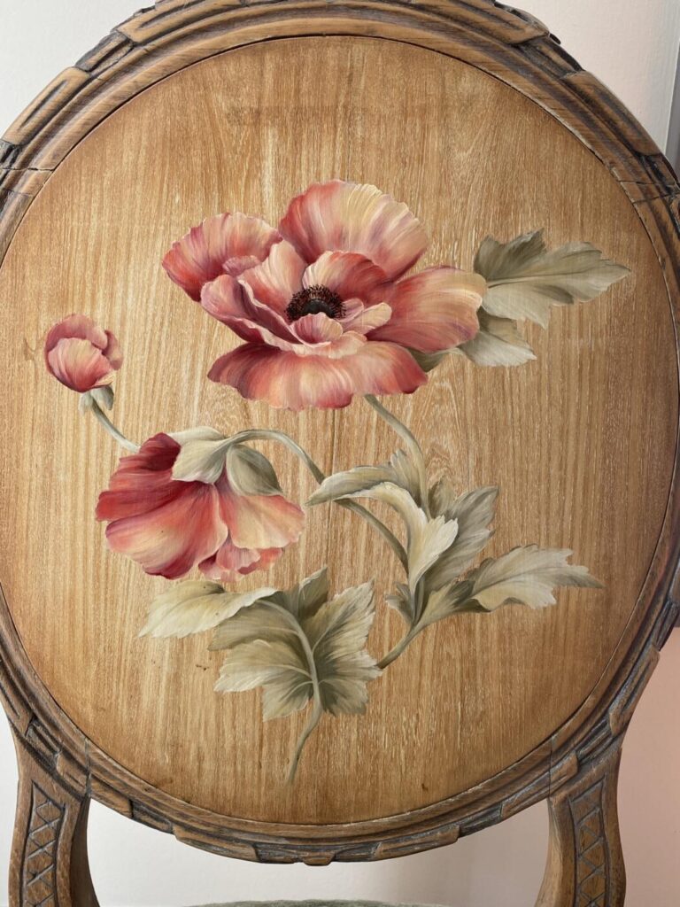 an image showing a close up of the painted back of the chair with the peony design