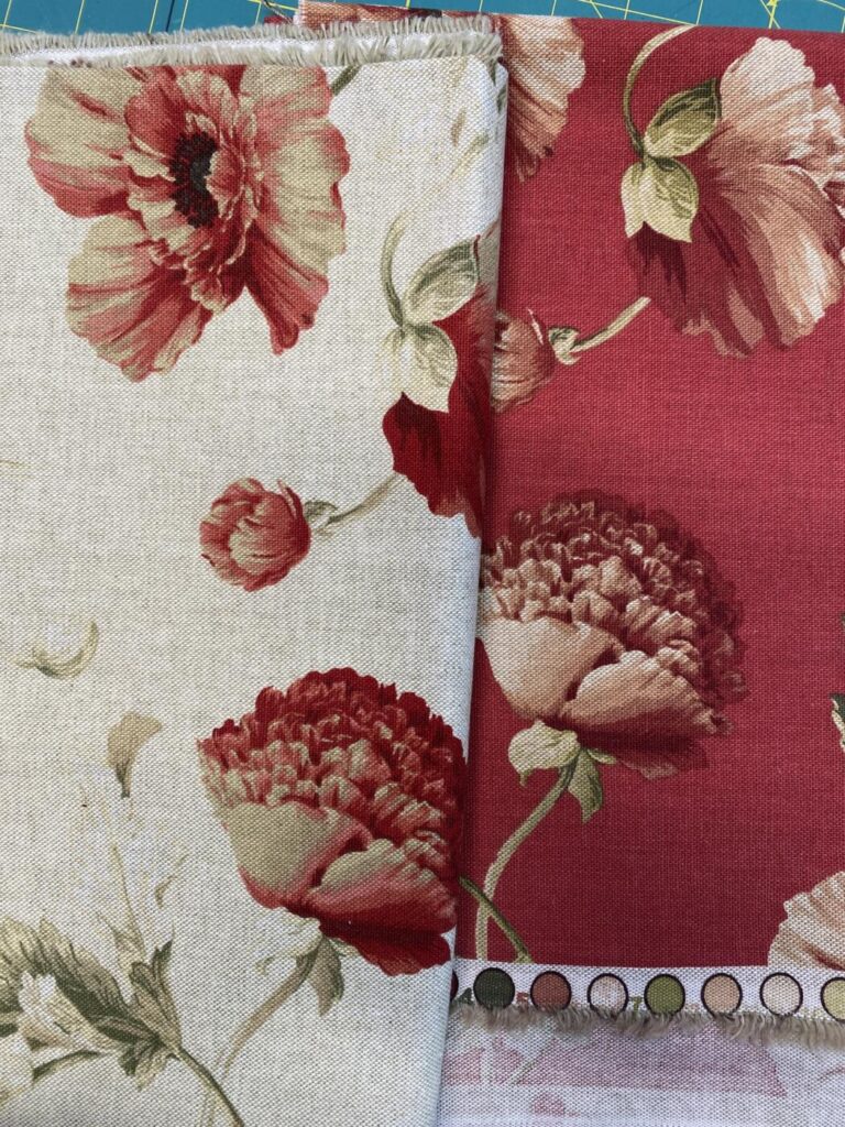 an image of two pieces of linen fabric with the peony design that inspired the painted chair